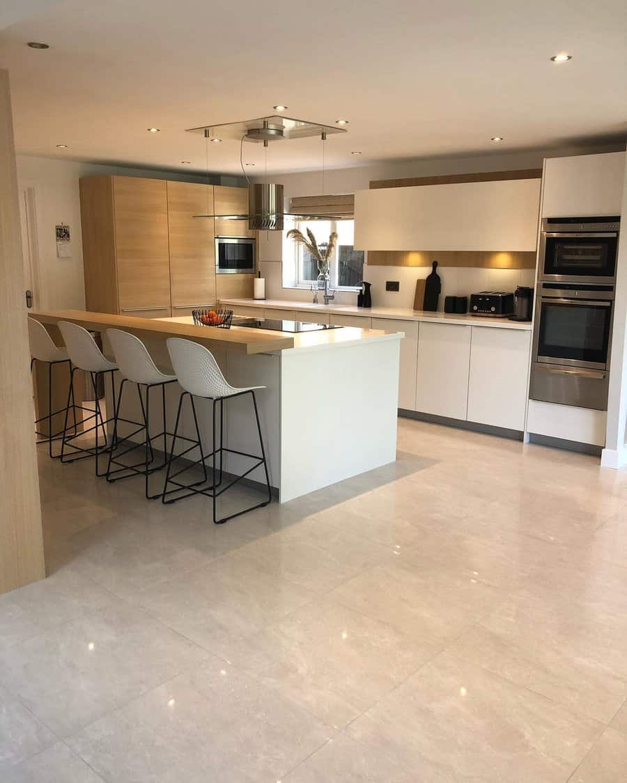 Modern kitchen with bar stools and polished floor tiles