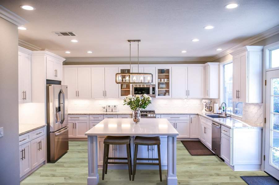 Elegant white kitchen with island and pendant lights