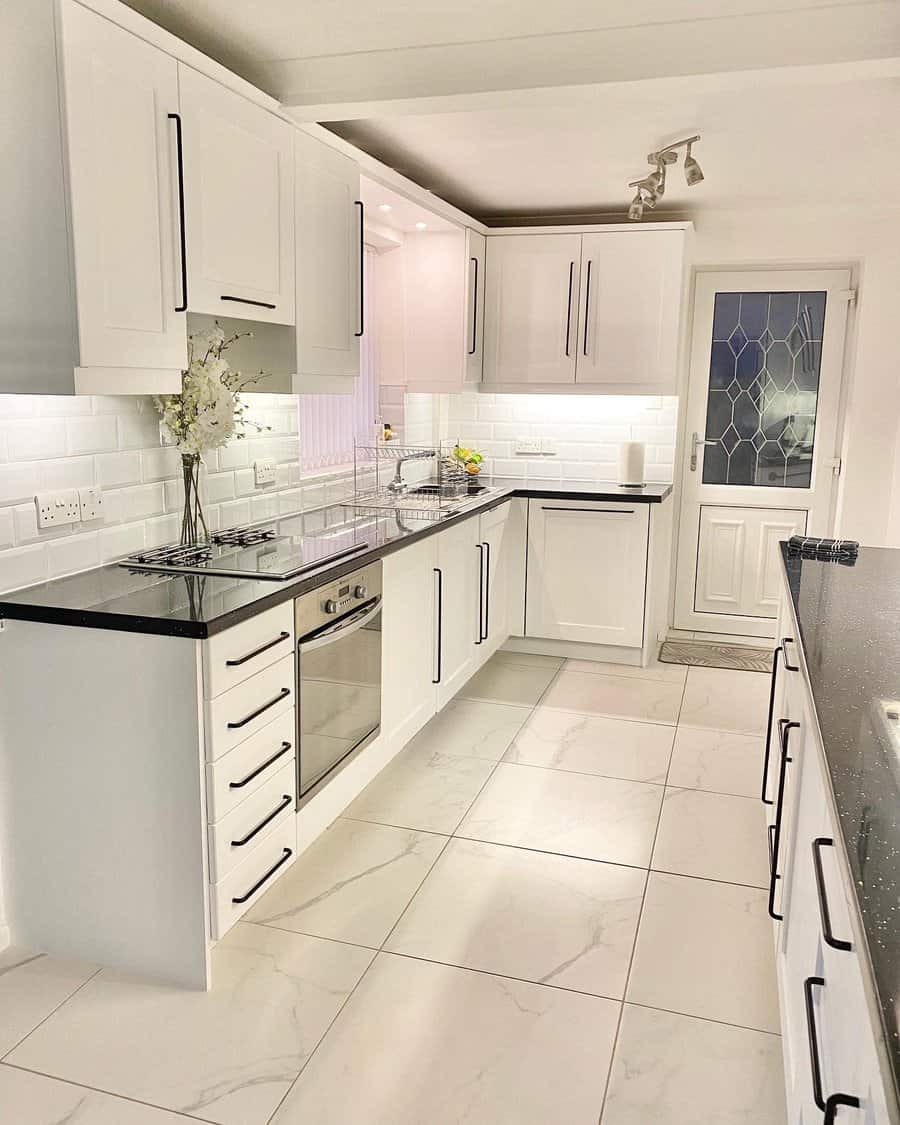 Elegant kitchen featuring white cabinetry