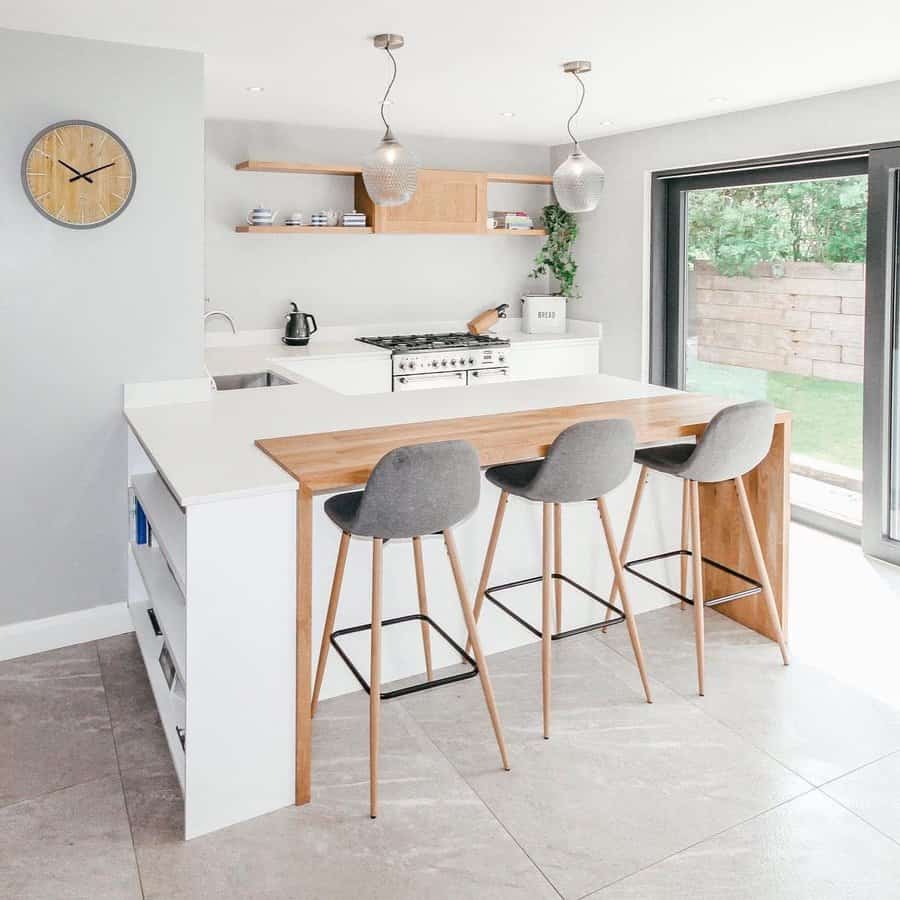 Stylish kitchen with pendant lights and wooden stools