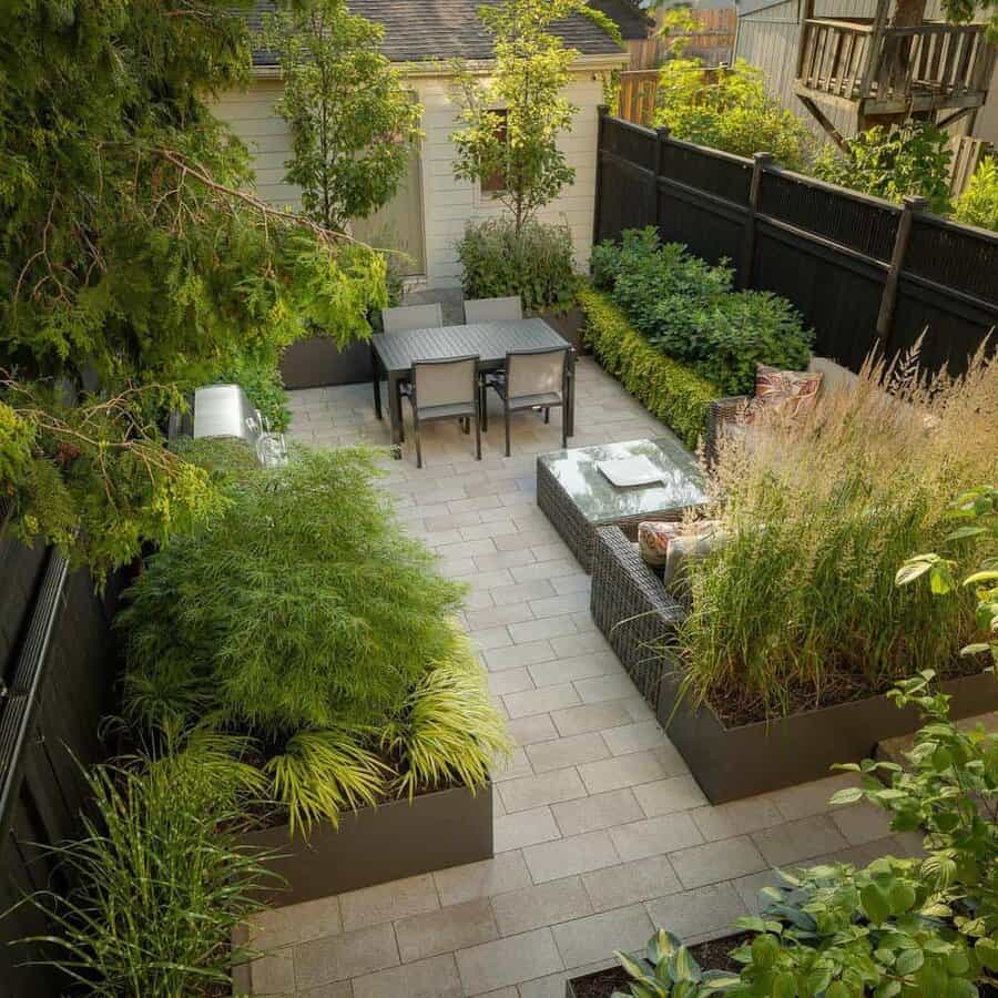 Secluded patio area with lush planter boxes and outdoor furniture