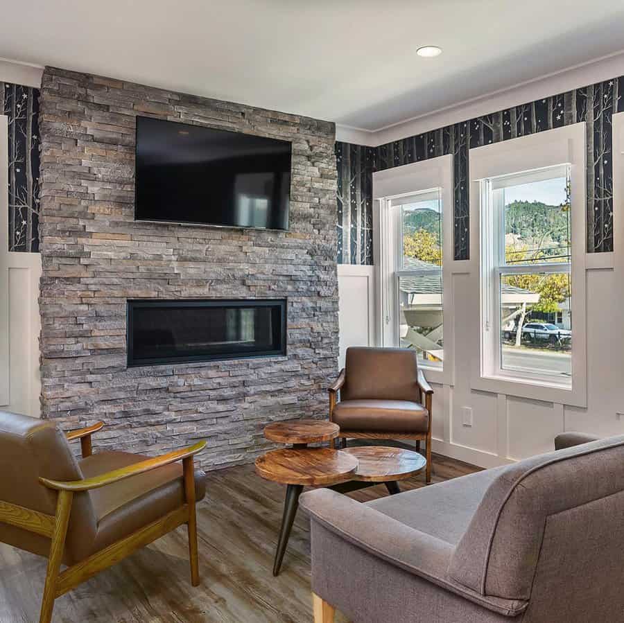 Modern living room with stone wall fireplace and sleek furniture