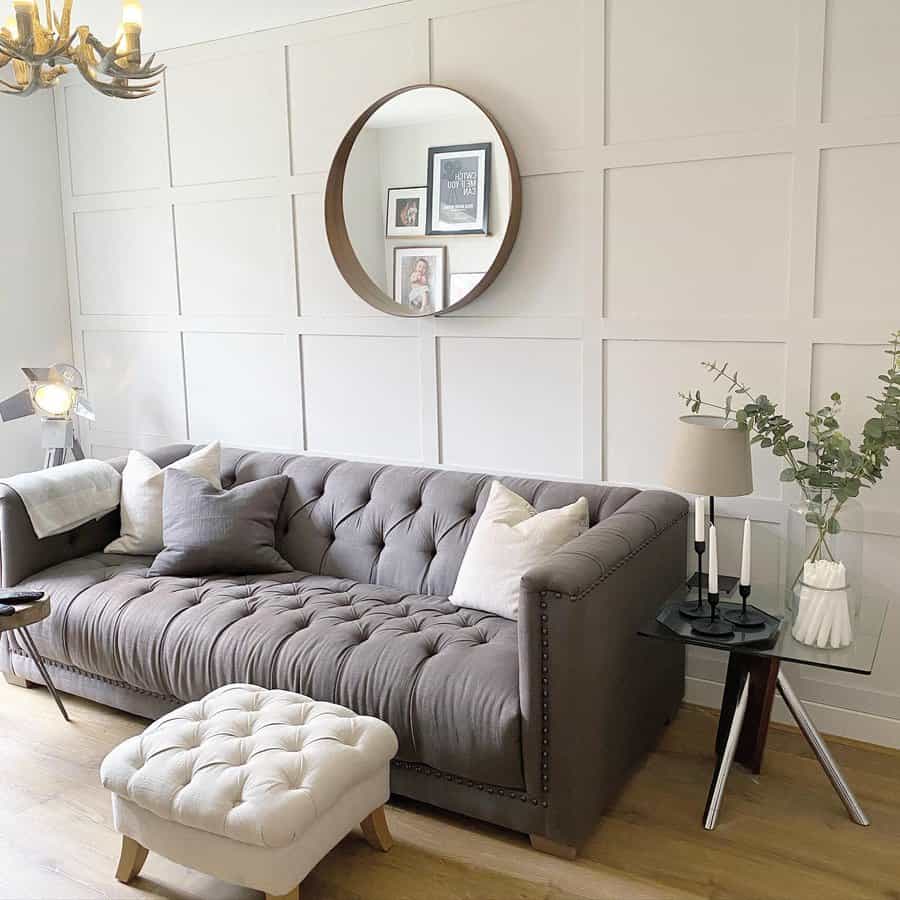 Elegant living room with tufted sofa and panel wall