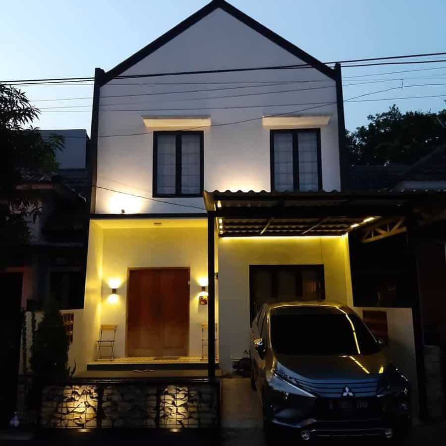 Two-story house with a lit front entrance