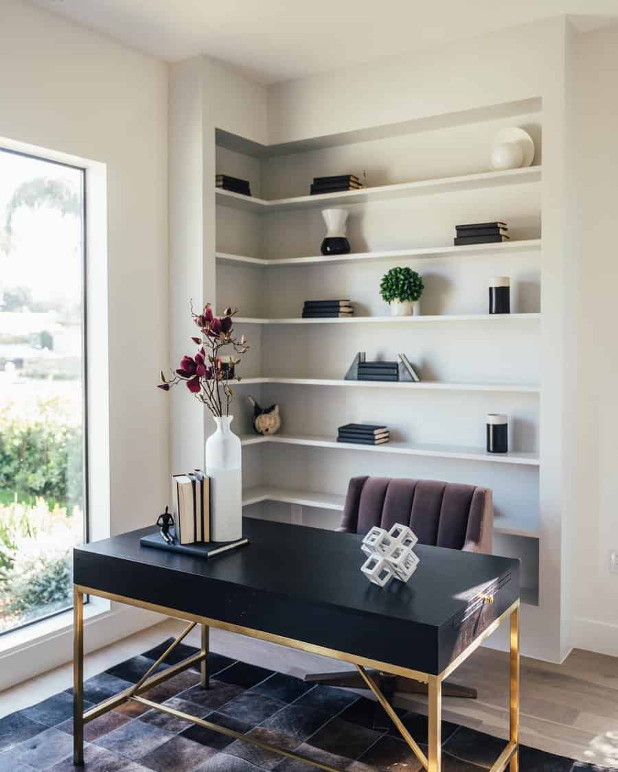 Modern home office with a sleek black desk, gold accents, bookshelves, decorative items, large window, and a chair