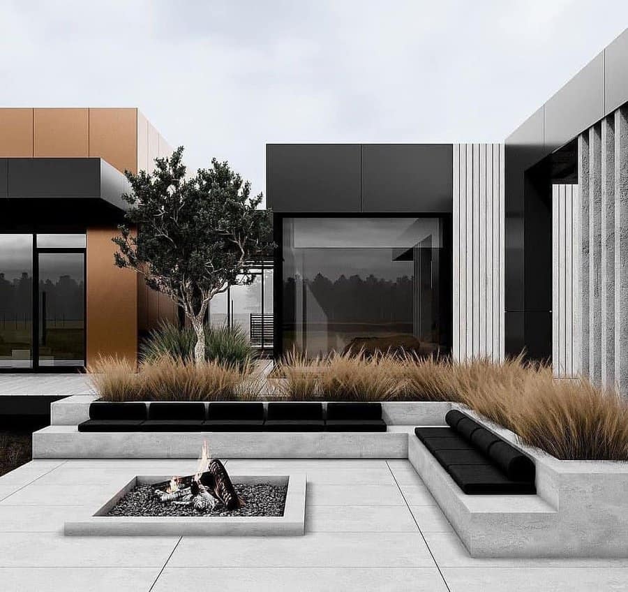 Modern patio with a sunken seating area around a fire pit, featuring sleek geometric architecture with black, brown, and gray tones