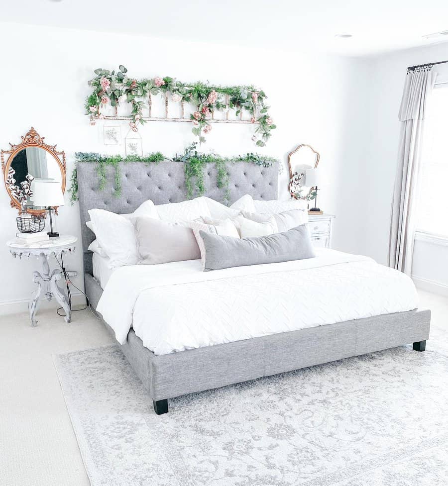 Romantic bedroom with floral headboard and vintage mirrors