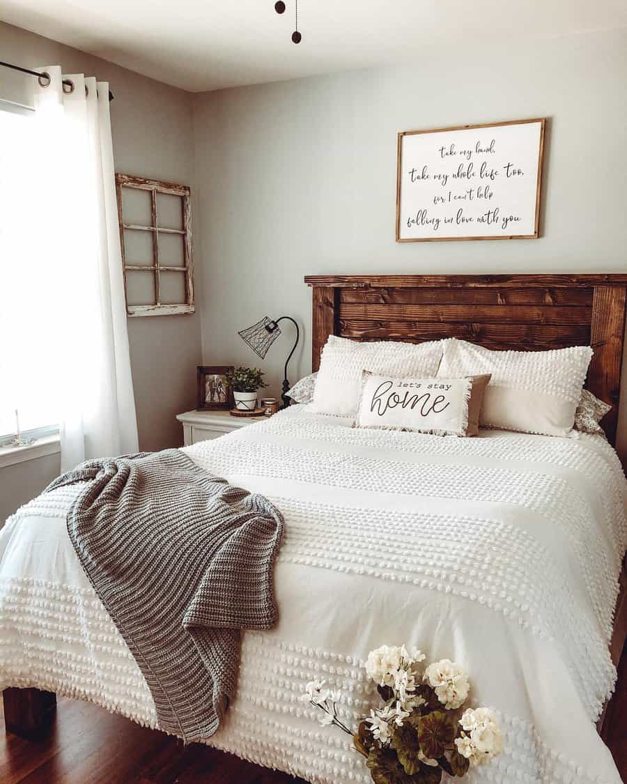 Homely bedroom with rustic headboard and quote art.