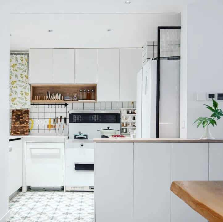 Modern kitchen with patterned floor and white tiles