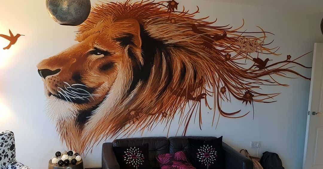 Mural of a lion's head with flowing mane and birds on a living room wall