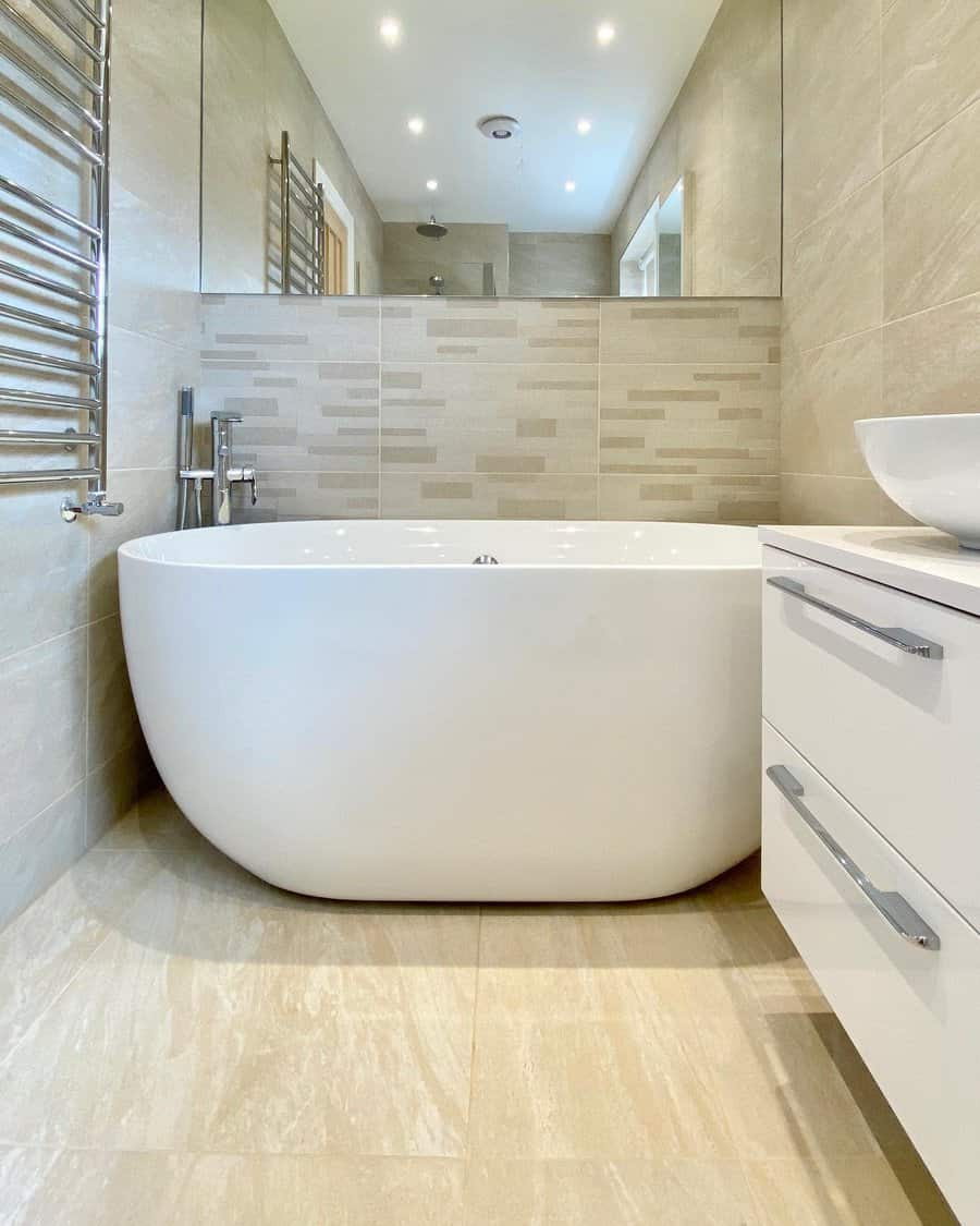 Bright bathroom with freestanding tub and neutral tiles