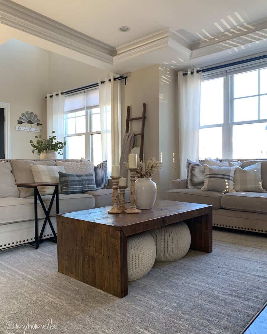 Sunlit living room with plush sofas and wooden coffee table