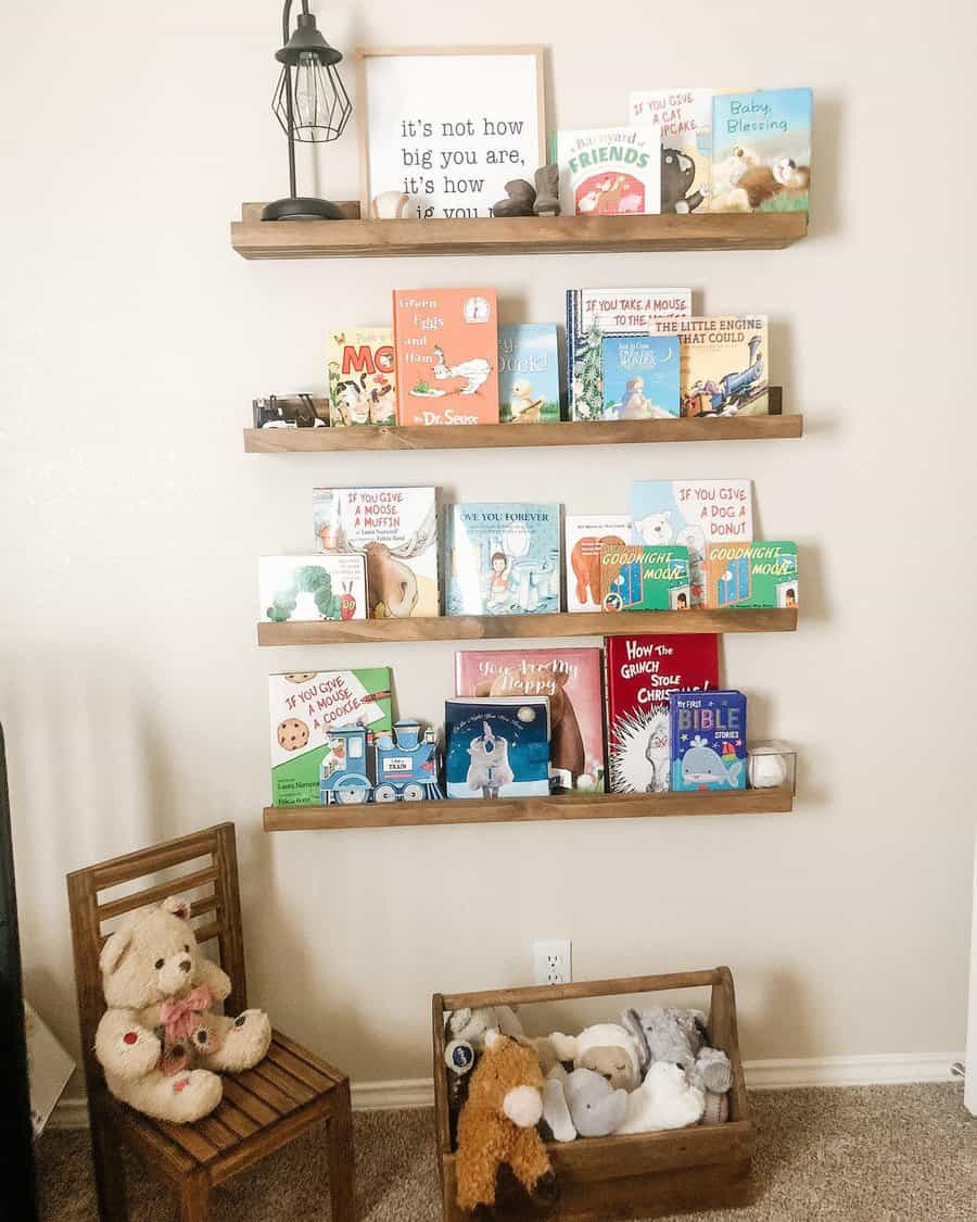 Warm and inviting nursery reading nook with floating wooden bookshelves filled with children's books, a wooden chair, and a toy storage crate.