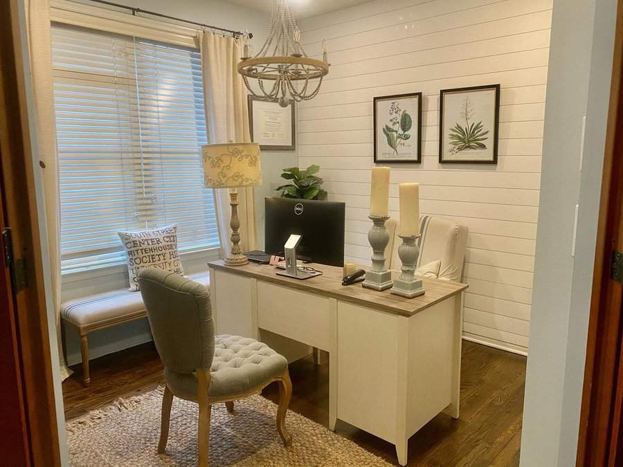 Home office with white shiplap walls and elegant decor