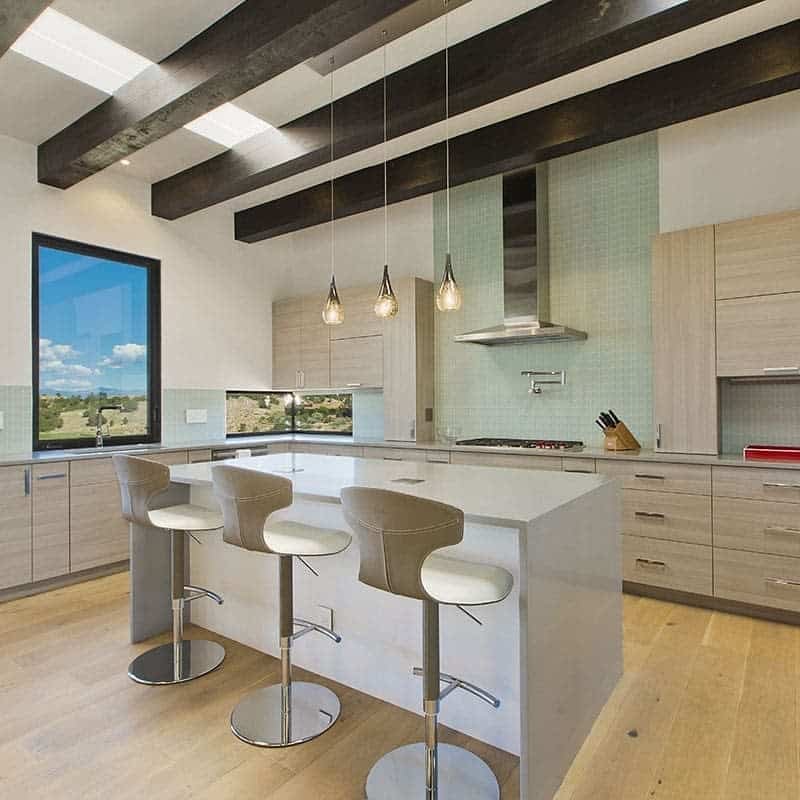 Bright kitchen with high ceilings and bar stools