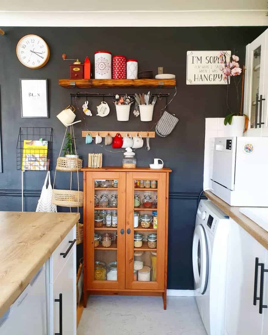 Cozy kitchen with a wooden pantry cabinet, open shelves, hanging mugs, and decorative storage solutions for an organized, rustic look