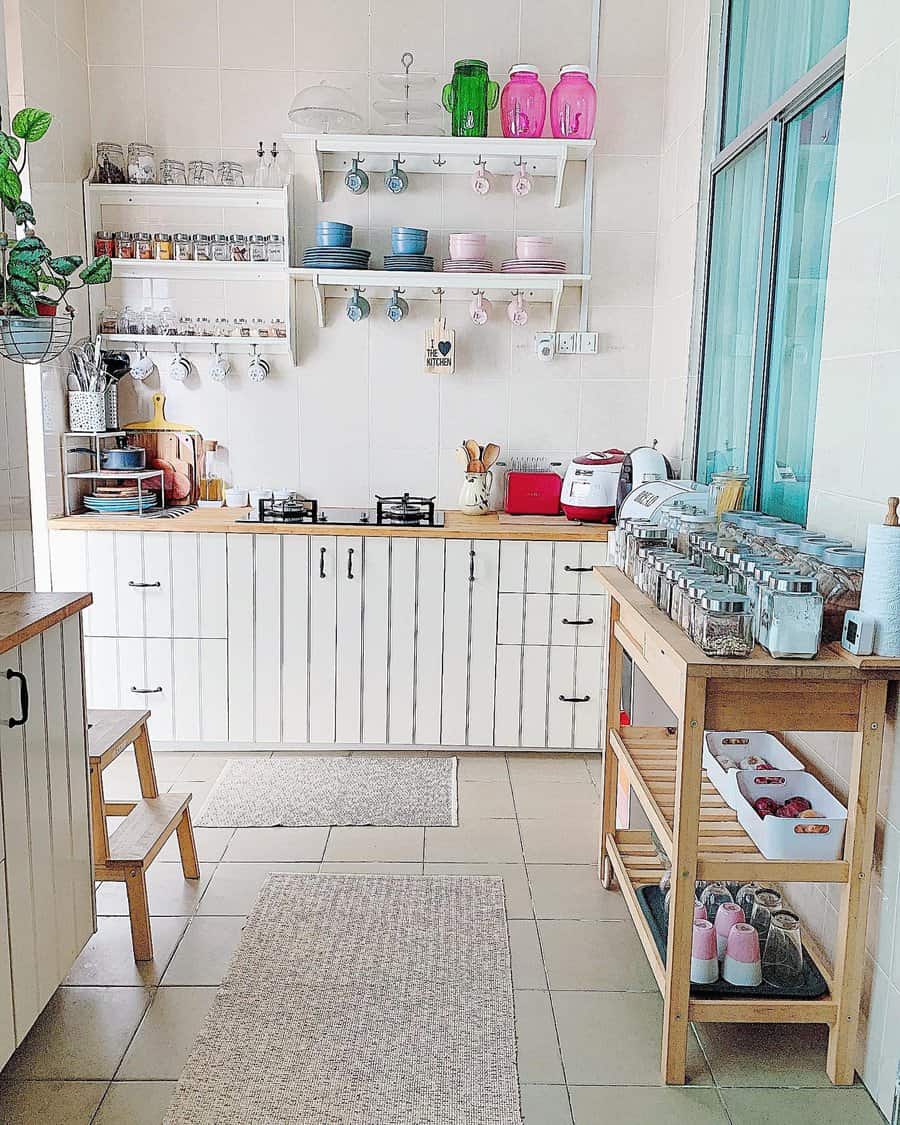 Bright and organized kitchen with open shelves, labeled jars, hanging mugs, and wooden cabinets for a clean and functional space