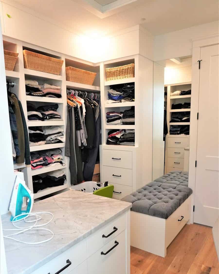 Walk in closet with island cabinet