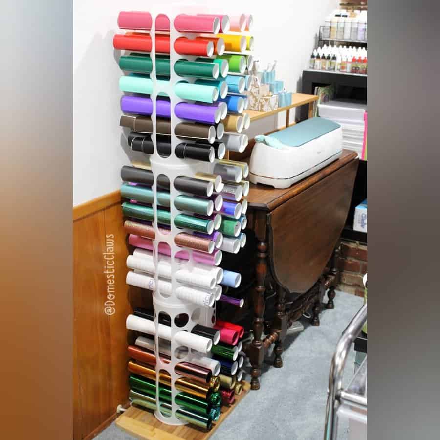 Vinyl roll organizer beside a crafting desk