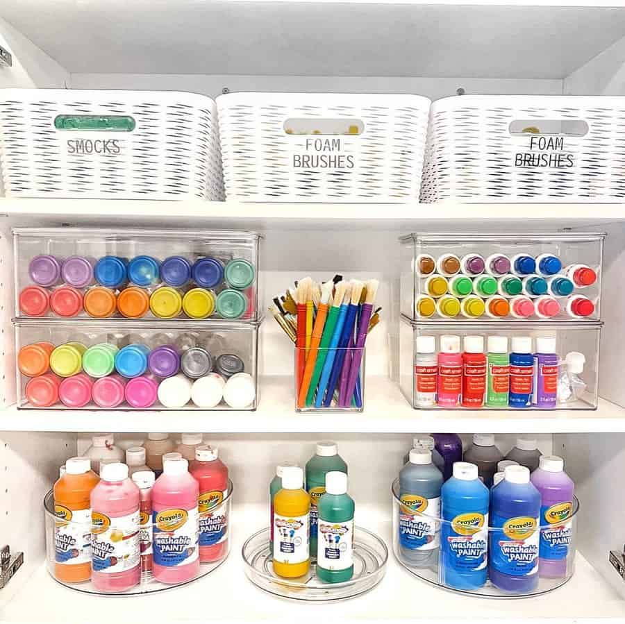 Paint supplies neatly arranged on white shelves