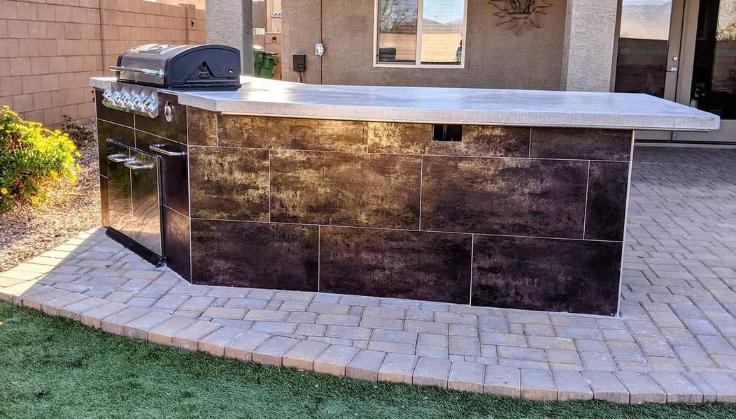 Modern outdoor kitchen bar with metallic finish and barbecue grill