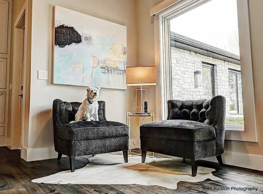 Black sofa in the living room with a wall painting