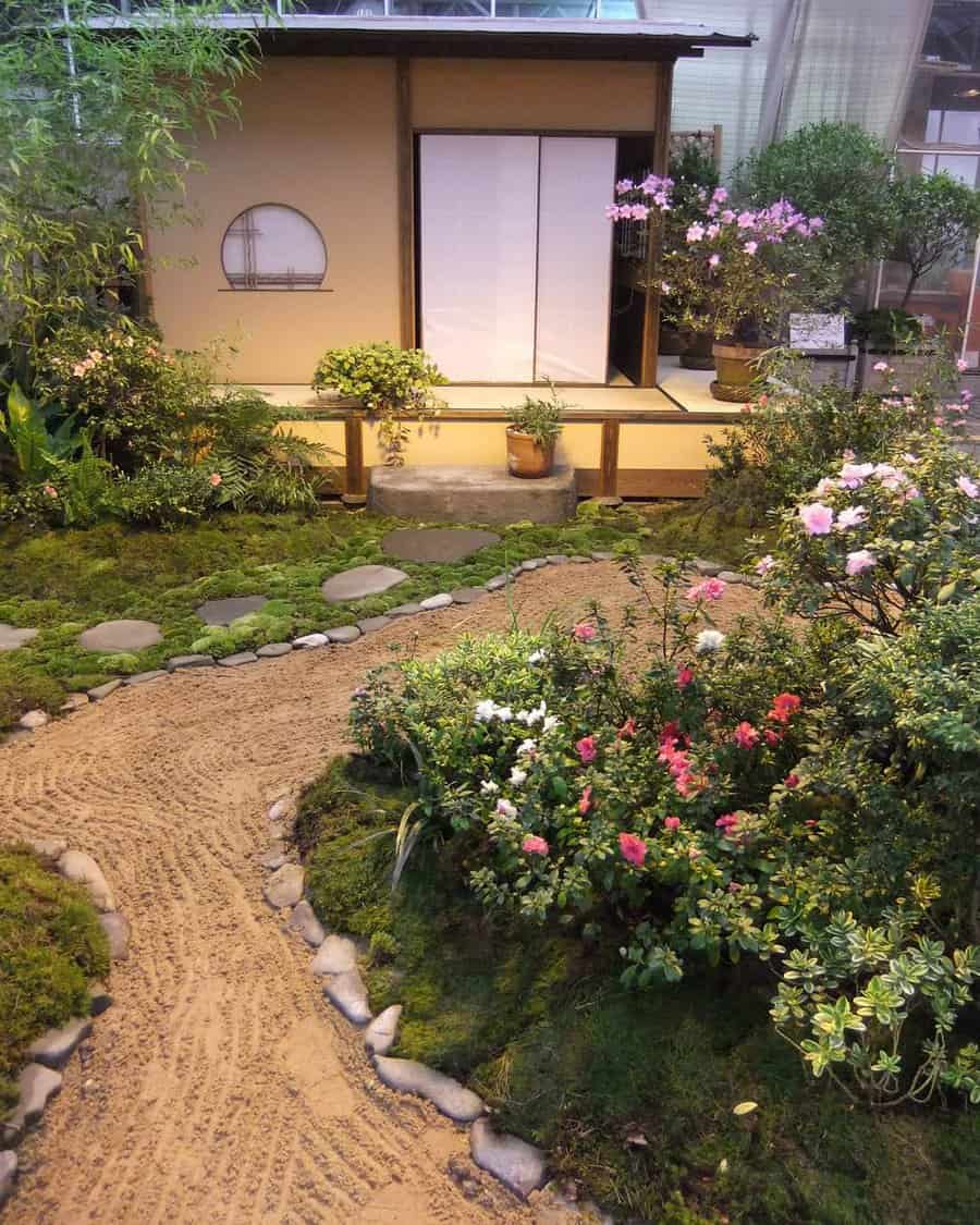 A traditional Japanese garden with a stone path, vibrant flowers, and a tea house with sliding doors in the background