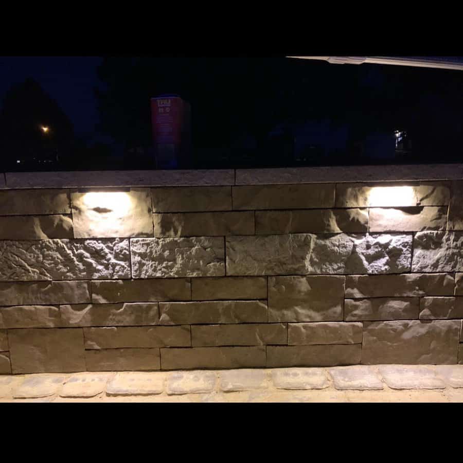 Stone wall with built-in lighting at night