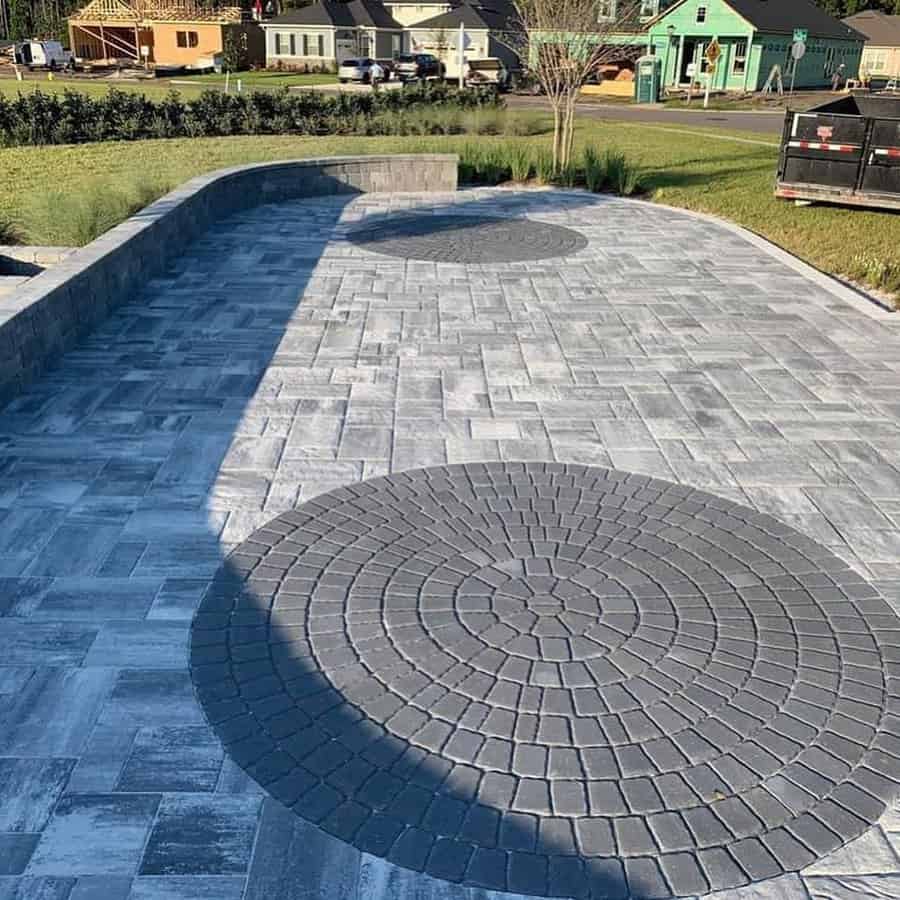 Paver patio with circular design and retaining wall