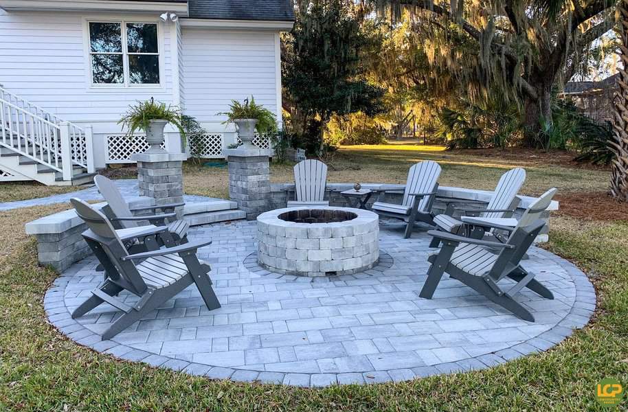 Circular paver patio with fire pit and Adirondack chairs