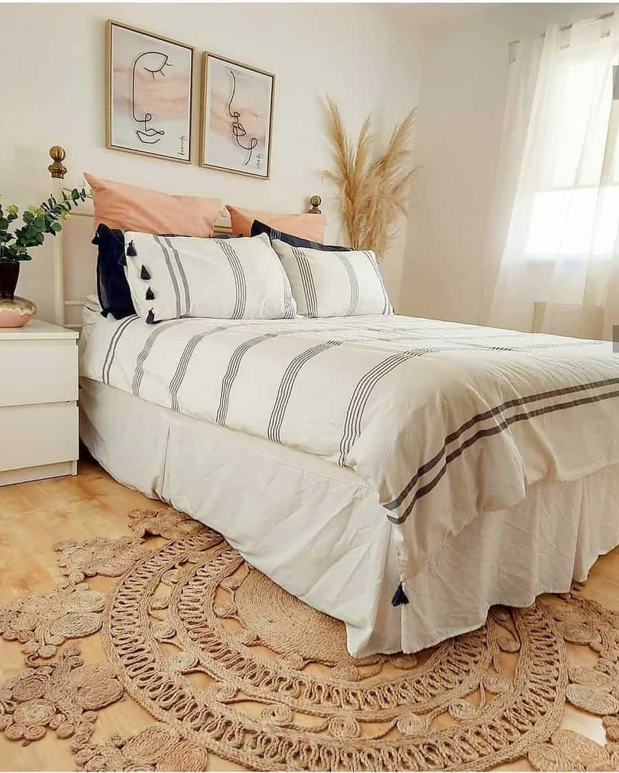 Calm Zen bedroom with soft striped bedding, earthy decor, woven rug, pampas grass, and warm neutral tones for a peaceful, airy ambiance