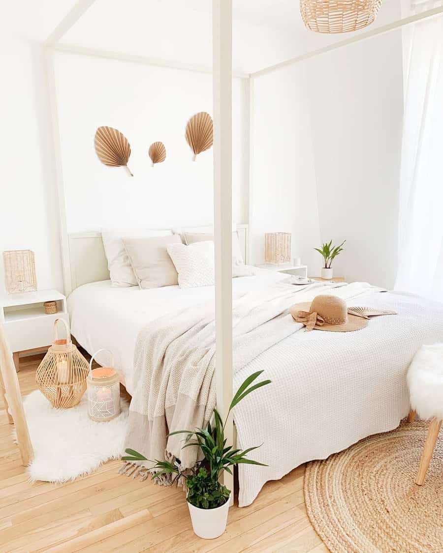 Elegant white bedroom with potted plant and fan wall art