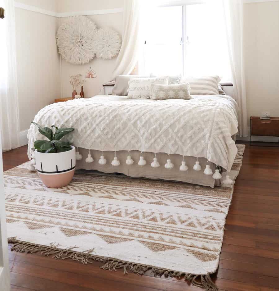 Serene Zen bedroom with soft neutral tones, layered textures, cozy tassel bedding, and natural light for a peaceful, inviting retreat