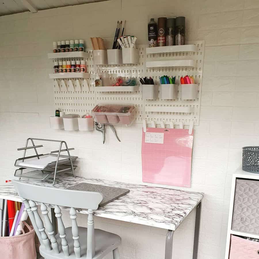 Craft corner with pegboard storage and marble desk