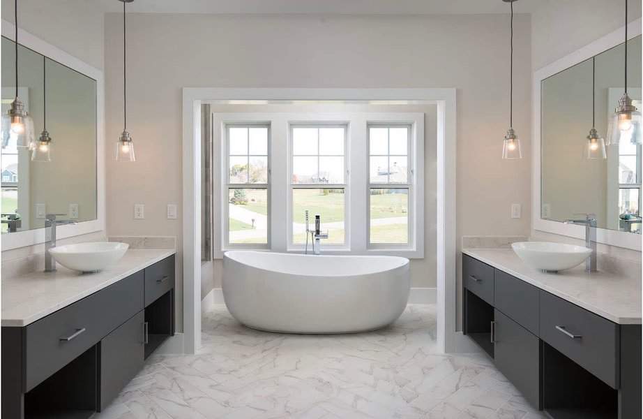 Bright bathroom with dual vanities and pendant lighting