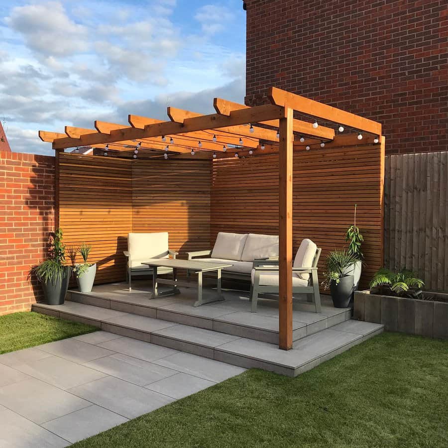 Elegant pergola over patio with lounge furniture and plants