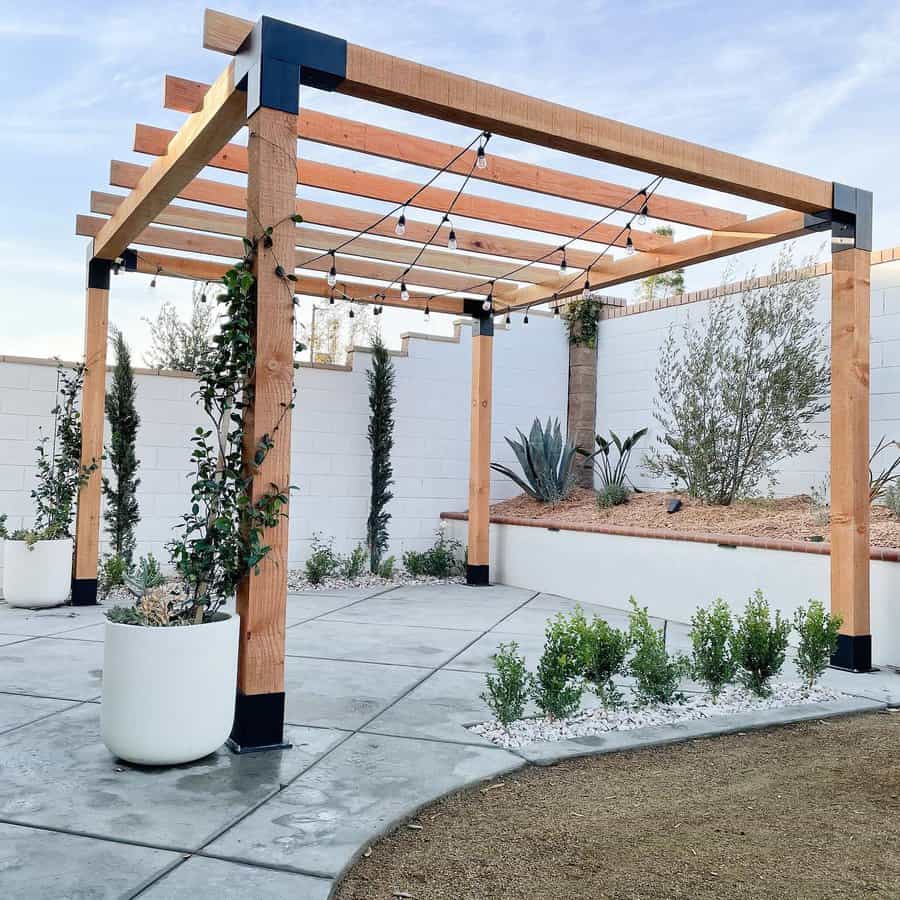 Modern pergola with lighting and white privacy wall