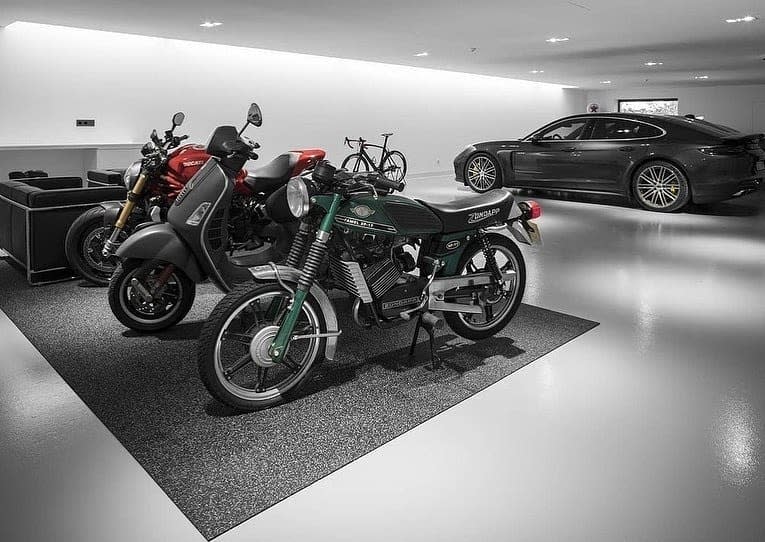 Modern garage with motorcycles and a luxury car