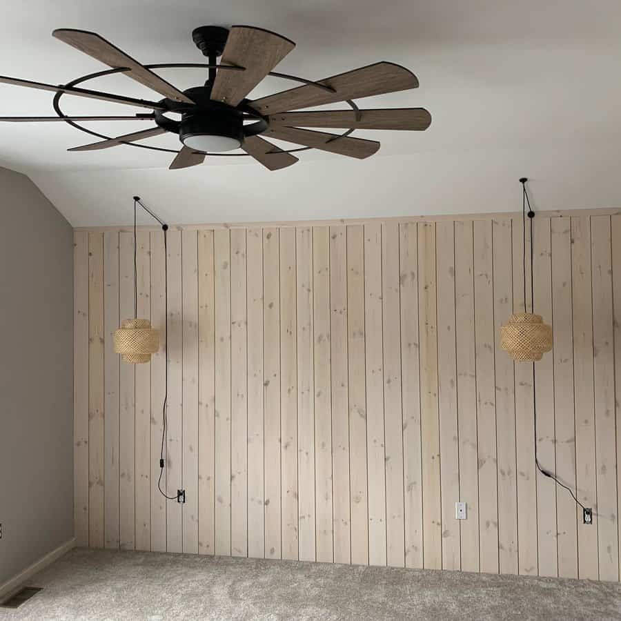 Minimalist room with pine shiplap wall and hanging wicker lamps