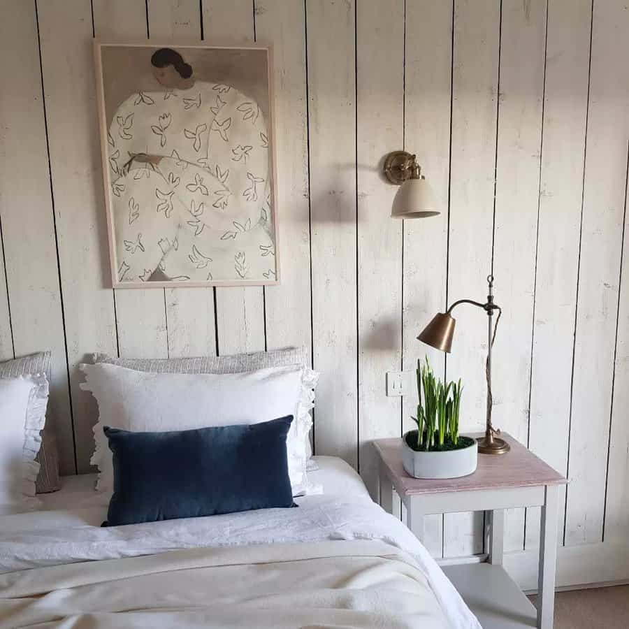 Rustic bedroom with wall art and wooden paneling