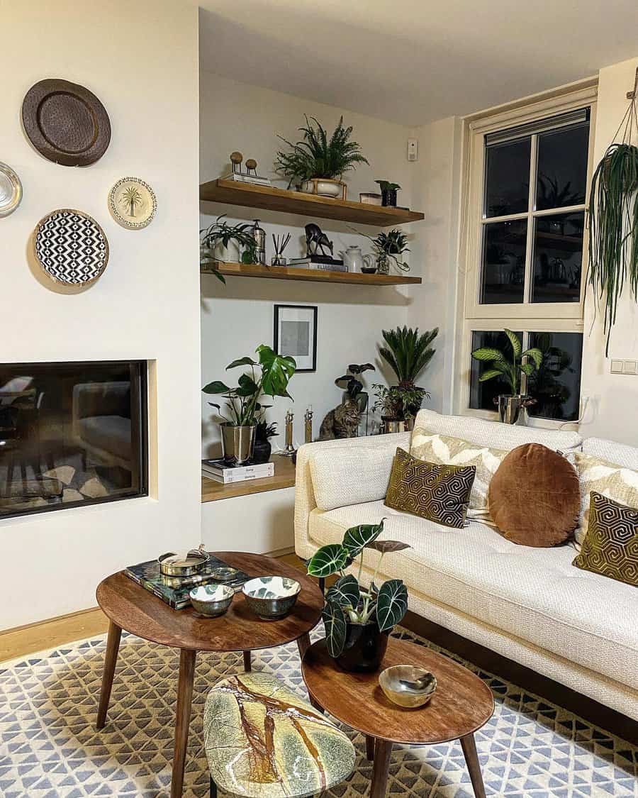 Cozy living room with plants, shelves, wall decor, white sofa, and wooden furniture