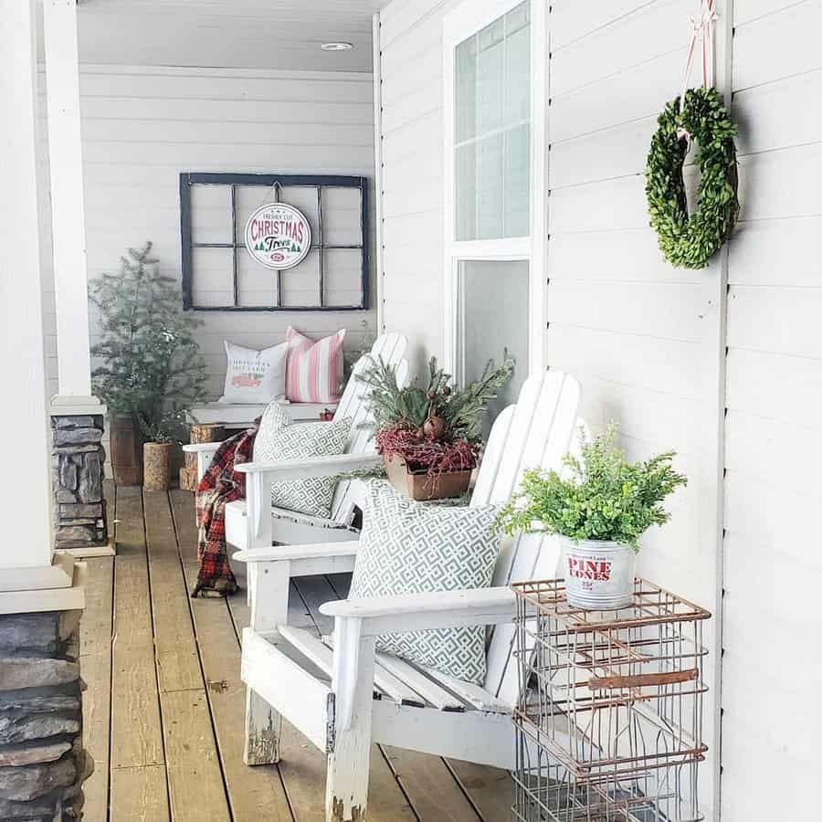 Cozy porch with white chairs, holiday decor, and potted plants