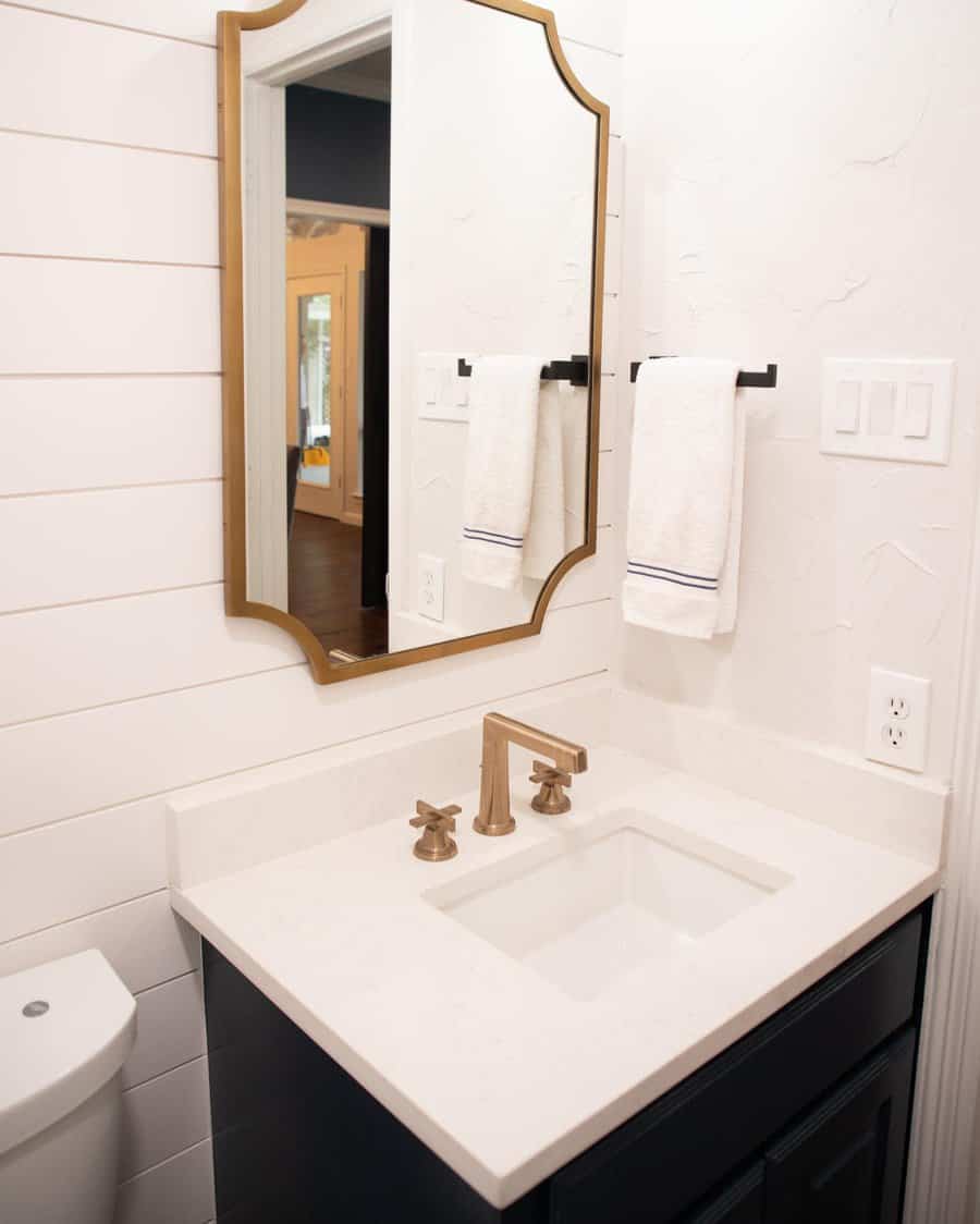 Half bathroom with statement mirror