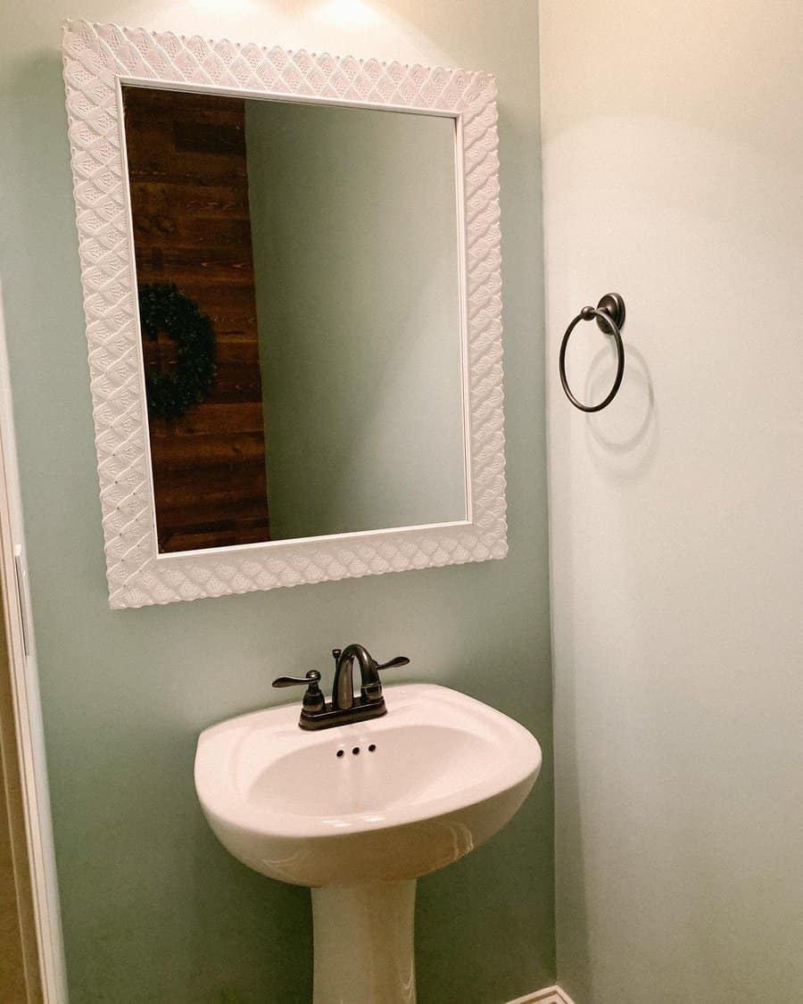 Half bathroom with statement mirror