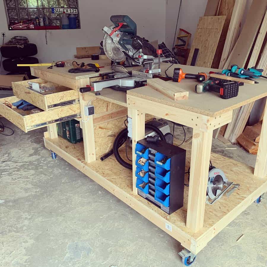 Wooden workbench with miter saw and power tools