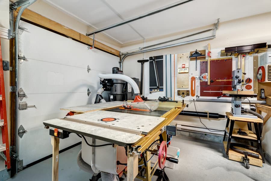 Garage workshop with saws and tool wall