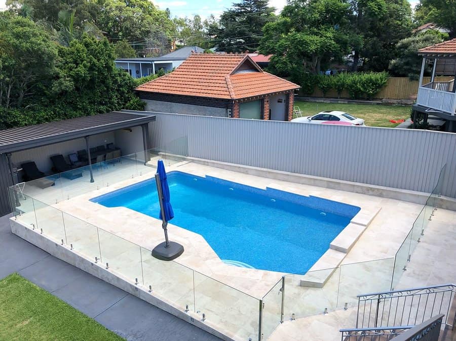 Glass fence and a metal privacy fence