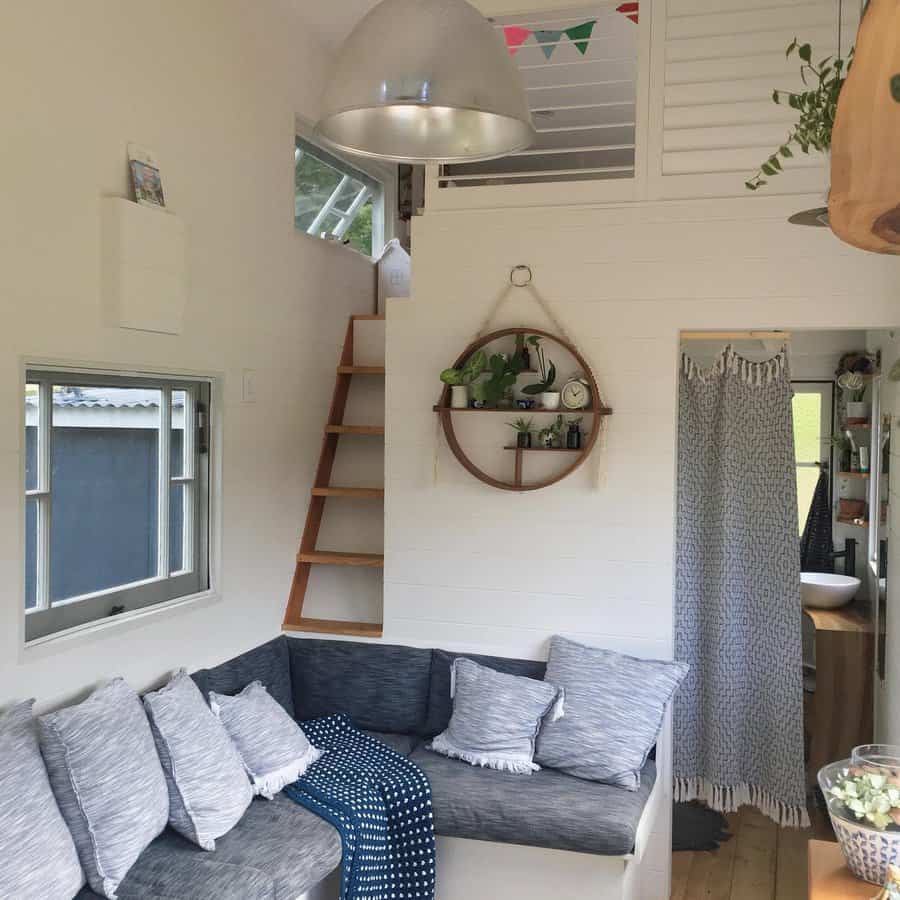 Tiny house interior with loft and cozy sofa