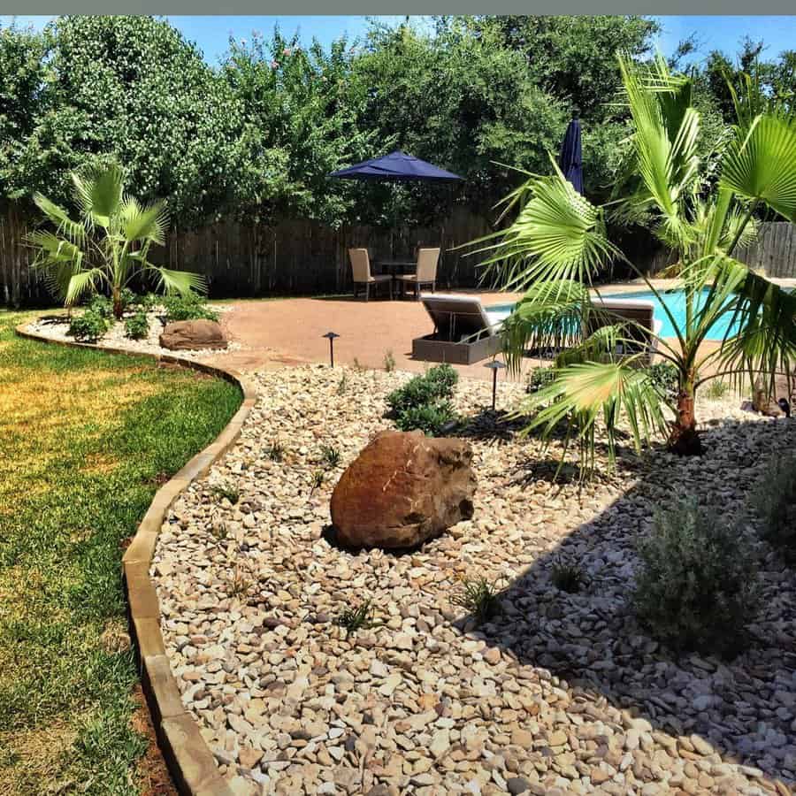 Tropical plants and pebbles pool landscape