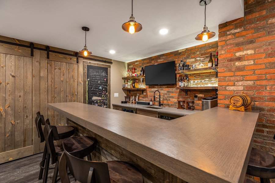 Rustic home bar with brick wall and wooden sliding door